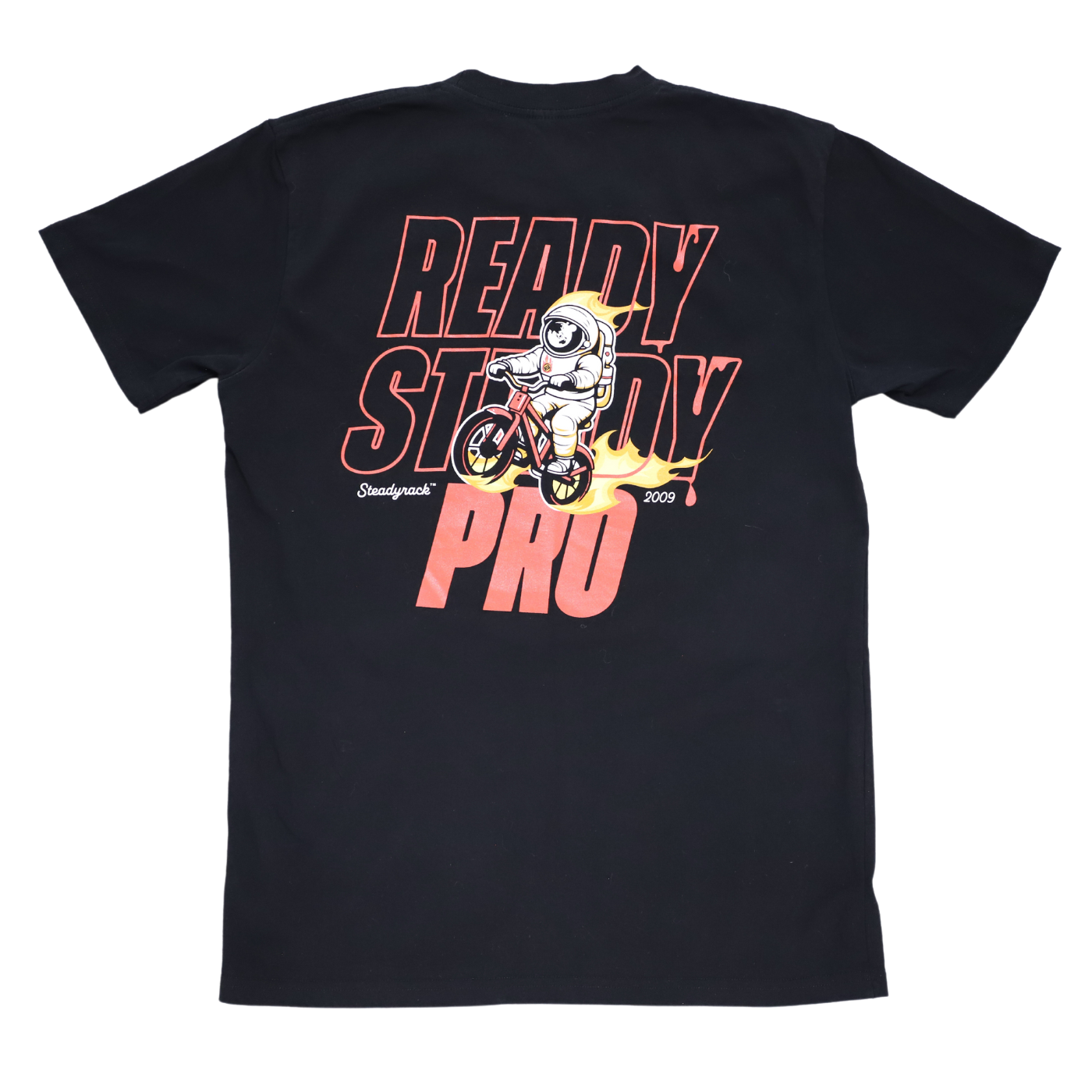 A Ready Steady Pro logo with an astronaut riding a bike surrounded in flames on the back of a black t-shirt.