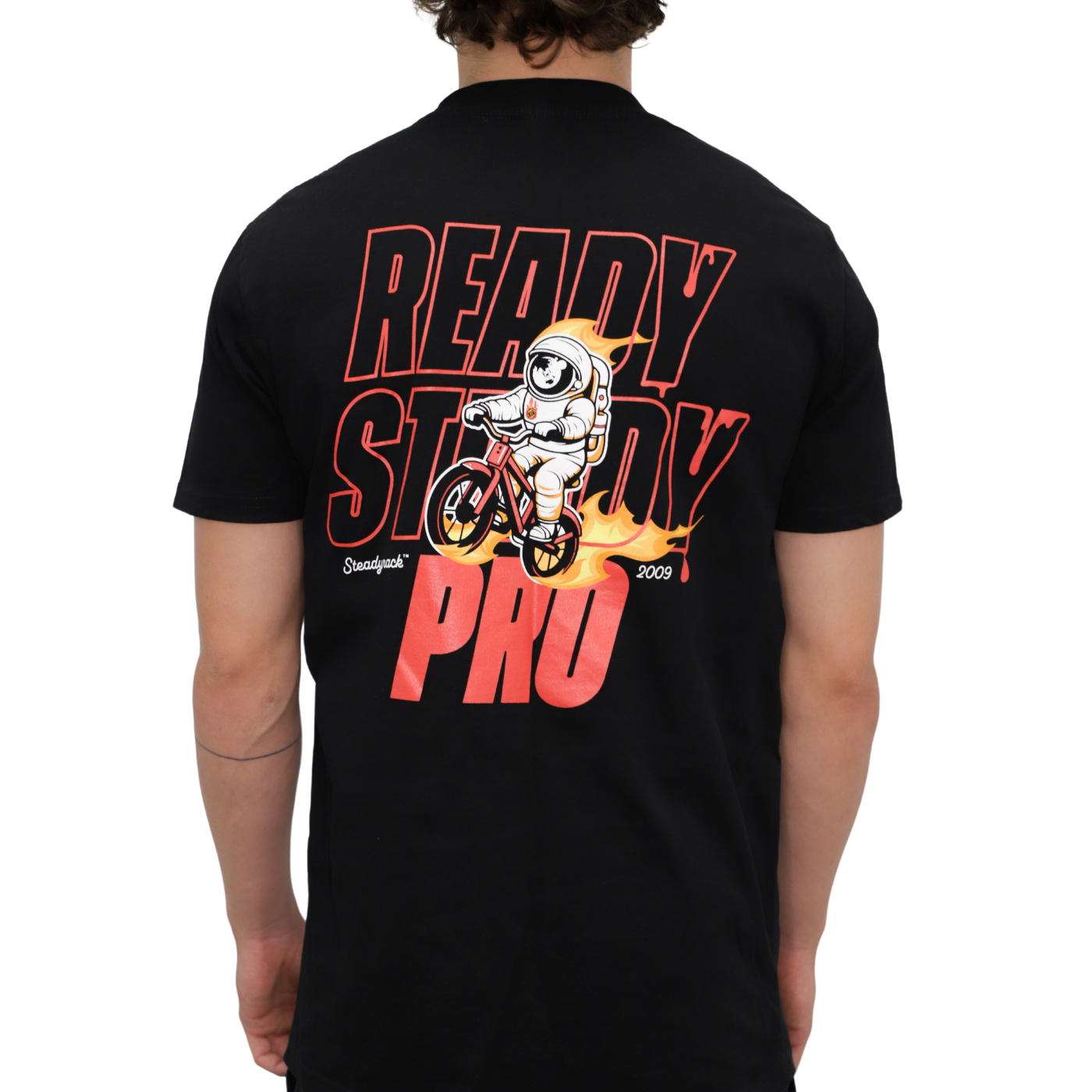 A model in a black t-shirt with an astronaut riding a bike with flames and a Ready Steady Pro logo.